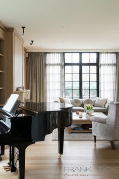 a living room filled with furniture and a piano