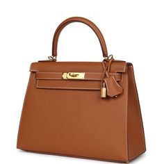 This Kelly, in the Sellier style, is in gold epsom leather with gold hardware and has contrast stitching, front flap, two straps with center toggle closure, clochette with lock and two keys a single rolled handle and removable shoulder strap.The interior is lined with gold chevre leather and has one zip pocket with an Hermes engraved pull and two open pockets on the opposite side.Collection: UOrigin: FranceCondition: New and never worn (plastic on hardware)Accompanied by: Hermes box, Hermes dustbag, clochette, lock, two keys, shoulder strap, clochette dustbag, shoulder strap dustbag, feltMeasurements: 11.25" width x 8.25" height x 4.75" depth; 3.5" handle drop (16.5" shoulder strap drop) Gold Epsom Leather Bag With Lock, Gold Epsom Leather Bag With Turn-lock Closure, Hermes Kelly Sellier, Kelly Sellier, Hermes Kelly 28, Gold Outfit, Hermes Birkin 25, Hermes Constance, Hermes Box