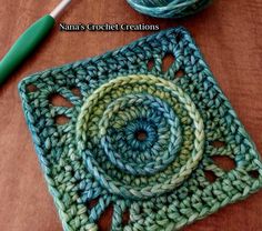 a crocheted square with a green ball of yarn next to it