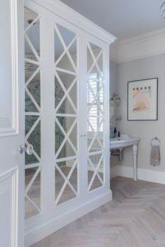 a large white cabinet with glass doors in a room