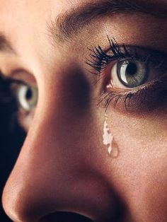 a woman's face with tears on her eye