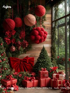 christmas decorations and presents are displayed in front of a window with red balls hanging from the ceiling