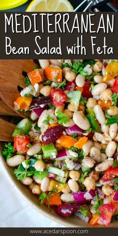 a salad with beans, carrots and lettuce in it