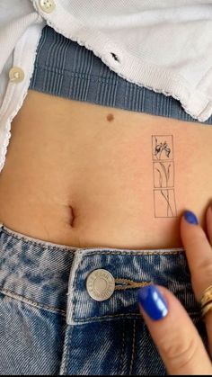 a woman's stomach with a small tattoo on it