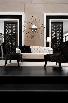 an elegant living room with black and white furniture