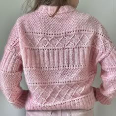 the back of a woman's pink sweater that has been knitted in two rows