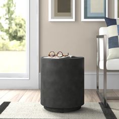 a pair of glasses sitting on top of a round table in front of a door