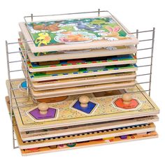 a stack of wooden puzzles sitting on top of each other in front of a white background