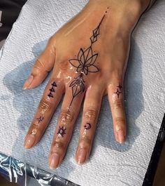 a woman's hand with tattoos on it