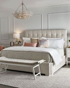 a bedroom with a bed, nightstands and chandelier in the middle of it