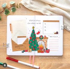 an open notebook with christmas decorations on it