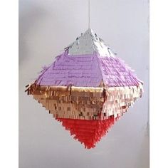 a hanging decoration made out of paper and other items in the shape of a pyramid