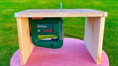 a table made out of wood with a power tool attached to the top and an electric nailing machine underneath it