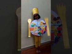 a child wearing a costume made to look like a plate and fork