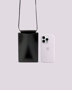 an iphone case and bag sitting next to each other on a gray background, with the phone in front of it