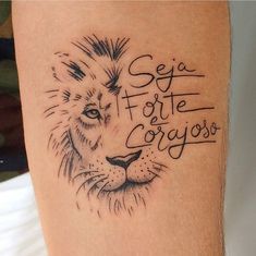 a tattoo on the leg of a person with a lion head and words written in cursive writing