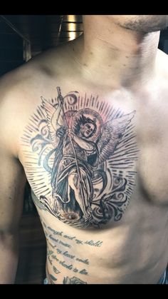 a man with a cross and angel tattoo on his chest