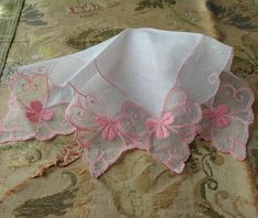 SPECIAL: Purchase 3 or more trims/Lace Collars/Doilies/Tobacco Silks/hankies/postcards or buttons and shipping is FREE ! Shipping will be refunded. GORGEOUS vintage linen and lace hanky perfect for a bride, wedding handkerchief. This fine hankie has exquisite, intricate and beautiful netted lace. It is a baby pink color with rose pink wide embroidery lace, sweet pink embroidery on netted lace.   It measures 10 inches by 10 inches, fine linen center, in wonderful condition. Would be very pretty to frame or make wonderful heirloom quality gifts for the bride or bridal party or any other special occasion. Small enough to be slipped into a greeting card for a lovely gift. Please do view our other beautiful vintage and antique hankies!  We combine shipping and ship internationally. Pink Handkerchiefs For Summer Gifts, Pink Spring Handkerchiefs For Gifts, Lace Hankies, Flapper Era, Lace Handkerchief, Lace Art, Pink Embroidery, Wedding Handkerchief, Baby Pink Colour