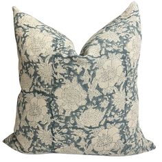 a blue and white pillow with flowers on it