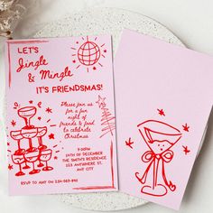 two pink cards with red ink on them sitting on a plate next to a flower