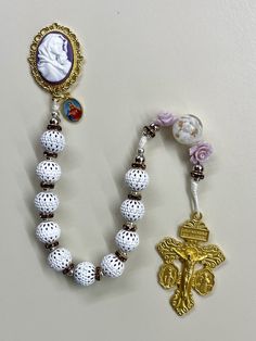 Welcome to my Shop "CREATING STILL MOMENTS."   To see all my listings and offerings, please visit my shop at  https://www.etsy.com/shop/CreatingStillMoments?ref=sh-carousel-1  Handmade Pocket Rosary ornate white beads with purple accents  Catholic Pocket Rosary with Cameo centerpiece, Catholic gift for women, Catholic mom gift, Tenner rosary These one of a kind handmade rosaries are beautiful and would make a wonderful mothers gift, Reconciliation or Confirmation gift, mom gift, Christmas gift! Chaplet Rosary, Pocket Rosary, Catholic Jewelry, Purple Accents, Rosary Necklace, Confirmation Gifts, Rosary Beads, Catholic Gifts, White Beads