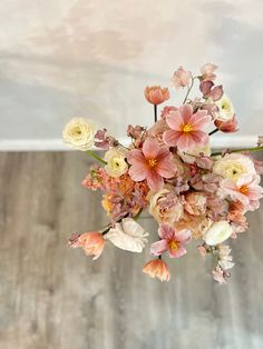 a vase filled with lots of pink and white flowers