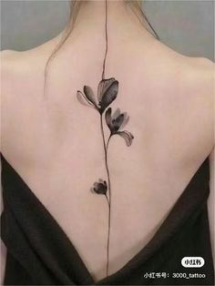 the back of a woman's neck with flowers painted on her upper and lower part