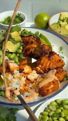 a bowl filled with meat and vegetables next to bowls of peas, avocado