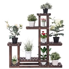 a wooden shelf filled with potted plants on top of each other and flowers in the middle