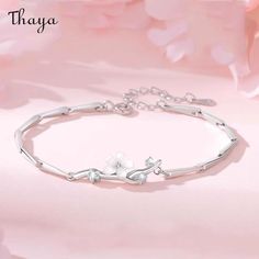 This striking Cherry Blossom Silver Bracelet is inspired by the symbolic beauty of Japan's national flower, the cherry blossom. The delicate and intricate design of the bracelet perfectly captures the fleeting nature of the blossom, making it a meaningful and symbolic piece of jewelry. Made from high-quality silver, it is perfect for daily wear, special occasions, or as a thoughtful gift.   - Brand: Thaya  - Material: 925 silver + Zircon+White shell  - Size: 14.5 + 3cm   - Style: Flower  - Gender: Women's Delicate Sterling Silver Flower Bracelets, Delicate Sterling Silver Flower Bracelet, Delicate Flower-shaped Sterling Silver Bracelets, Elegant Flower Bracelets, Elegant Sterling Silver Bracelets With Flower Charm, Elegant Sterling Silver Spring Jewelry, Elegant Sterling Silver Jewelry For Spring, Elegant Silver Flower Bracelets, Elegant Silver Bracelets For Spring