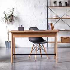 a wooden table with two chairs next to it