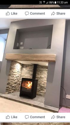 a fire place in the middle of a living room with stone walls and flooring