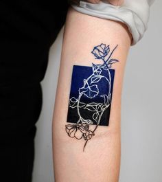 a woman's arm with a tattoo on it that has a flower in the center