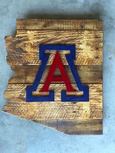 a wooden sign with the letter a on it