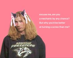 a man with long blonde hair wearing two paper cats on his head, and the caption says, because me, are you a mechanic by any chance?