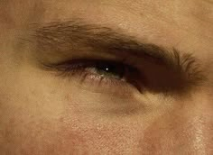 a man's eyes are shown with no makeup