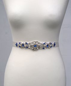 "Wedding Belt, Bridal Belt, Bridesmaid Belt, Bridesmaid Belt, Crystal Rhinestone/ Pearls Ready to ship This is lovely bridal belt with rhinestone crystal pearls applique. Fully encrusted with silver crystals and beads attached to double side satin ribbon. It will look great with any color dress, being either white, diamond, ivory, or antique. Looks great in the front , or on the side ! Made of : - rhinestone applique high quality with sparkin rhinestone and crystal win silver and blue color -the Elegant Blue Party Sashes, Elegant Blue Sashes For Wedding, Elegant Blue Bridal Belt For Wedding, Diy Wedding Dress Sash, Dress Sash Belt, Wedding Dress Sash Belt, Belt Wedding Dress, Bridesmaid Belt, Gatsby Headband