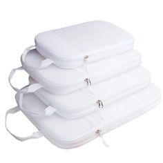 three pieces of white luggage sitting next to each other on top of a white surface