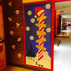 a door decorated with candy canes and christmas decorations in the hallway at an elementary school