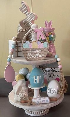 a three tiered cake decorated with easter decorations