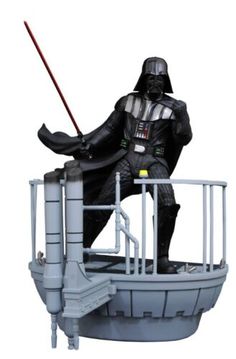 a statue of darth vader sitting on top of a boat with a light saber in his hand