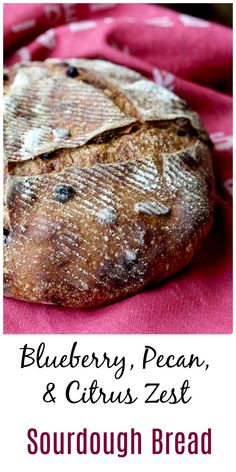 blueberry, pecan and citrus zest sourdough bread on a pink cloth