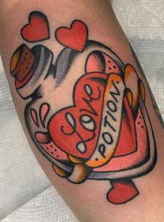 a tattoo on the arm of a woman with candy and hearts around it, that says love you