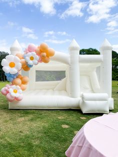 an inflatable bouncy house decorated with flowers