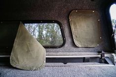 the back end of a vehicle with two mirrors on it's side and one window open