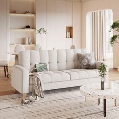 a living room filled with furniture and a white rug on top of a hard wood floor