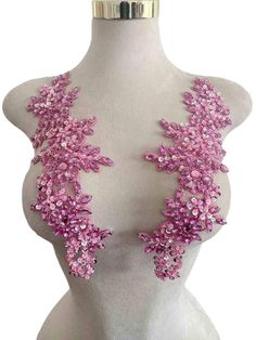 a white mannequin with pink flowers on it's chest and headpiece