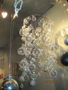 a chandelier hanging from the ceiling in a room with ornaments and lights around it