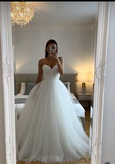 a woman taking a selfie in her wedding dress