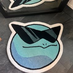 two bathroom rugs with an image of a cat on them